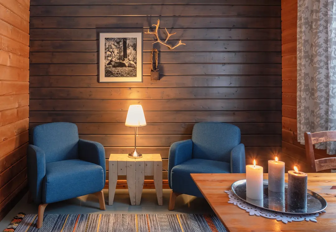 A quiet Lapland cabin interior with a fireplace, the kind of calm retreat space families can plan around