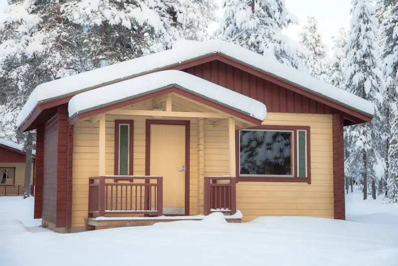 Fireplace cabin exterior in winter snow