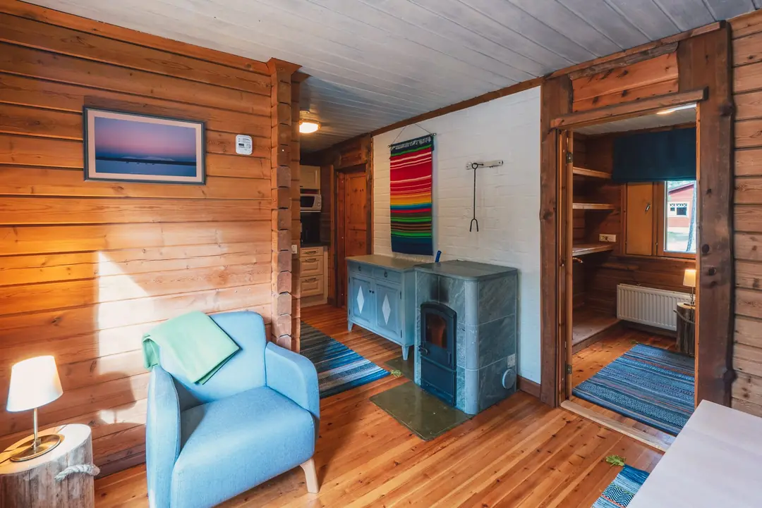 Fireplace cabin living area with cosy armchairs and fireplace