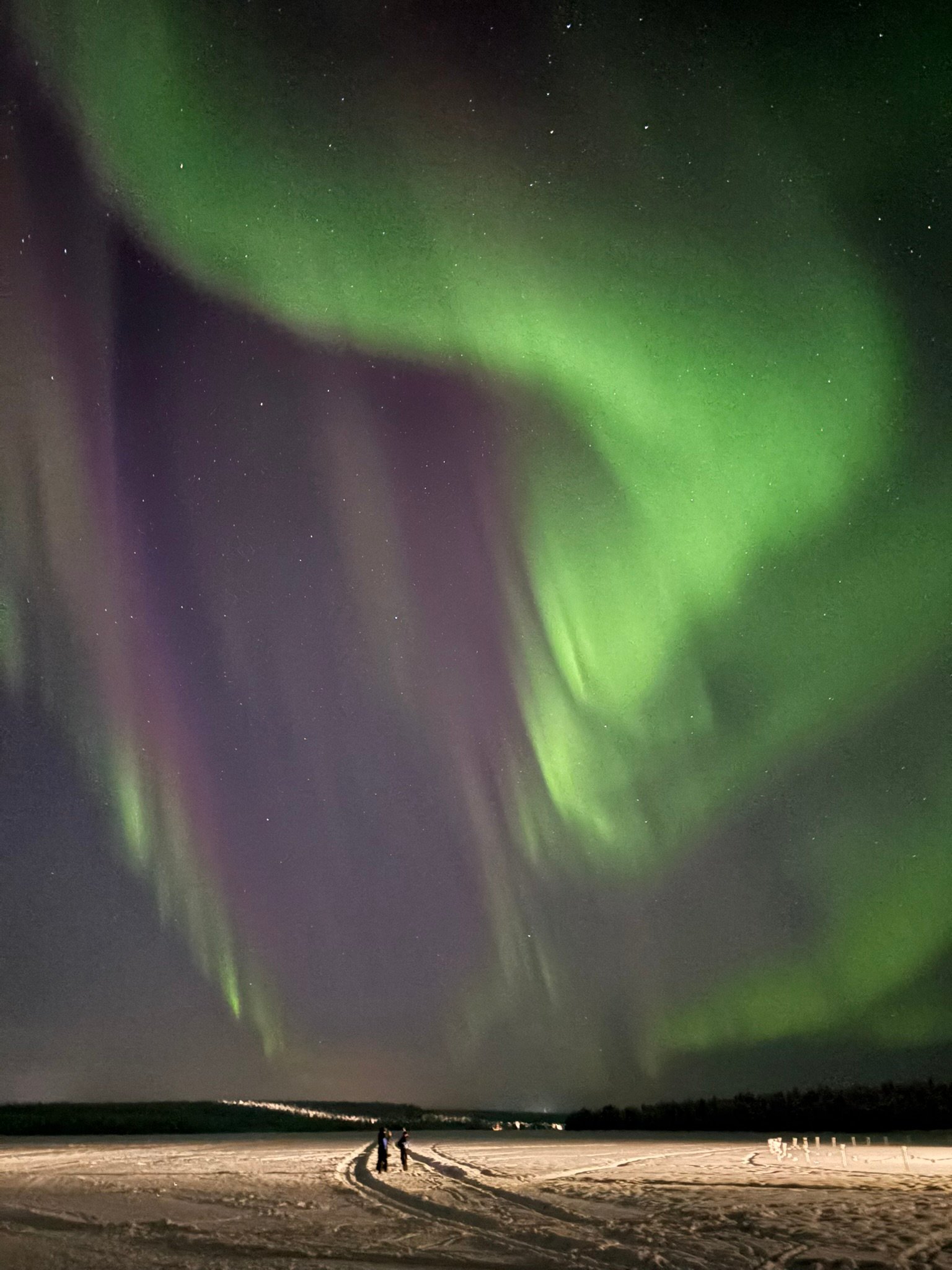 A snow-covered log cabin in Torassieppi, offering doorstep Northern Lights viewing without light pollution