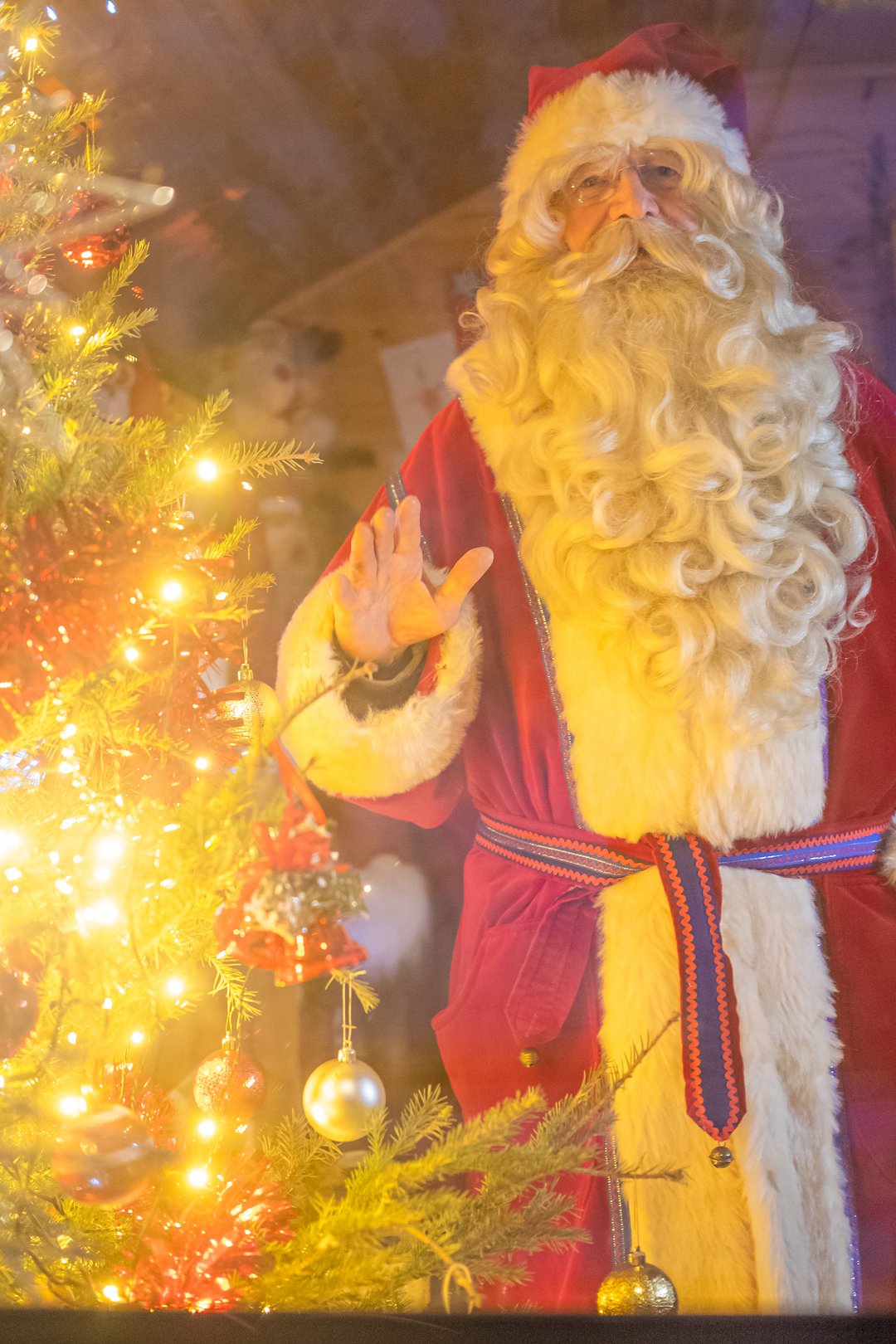 A toddler meeting Father Christmas in a private log cabin in Lapland