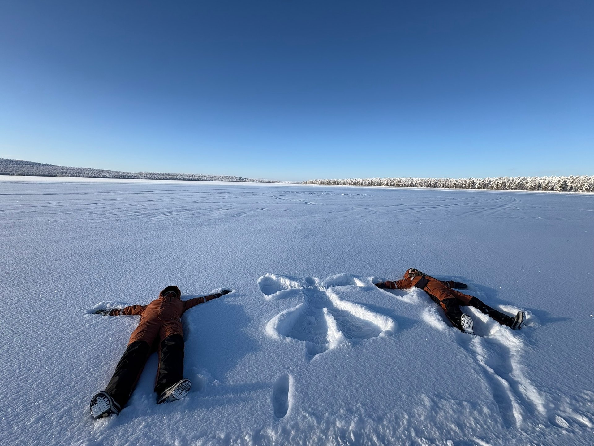 Family properly layered in Arctic gear enjoying the Lapland snow