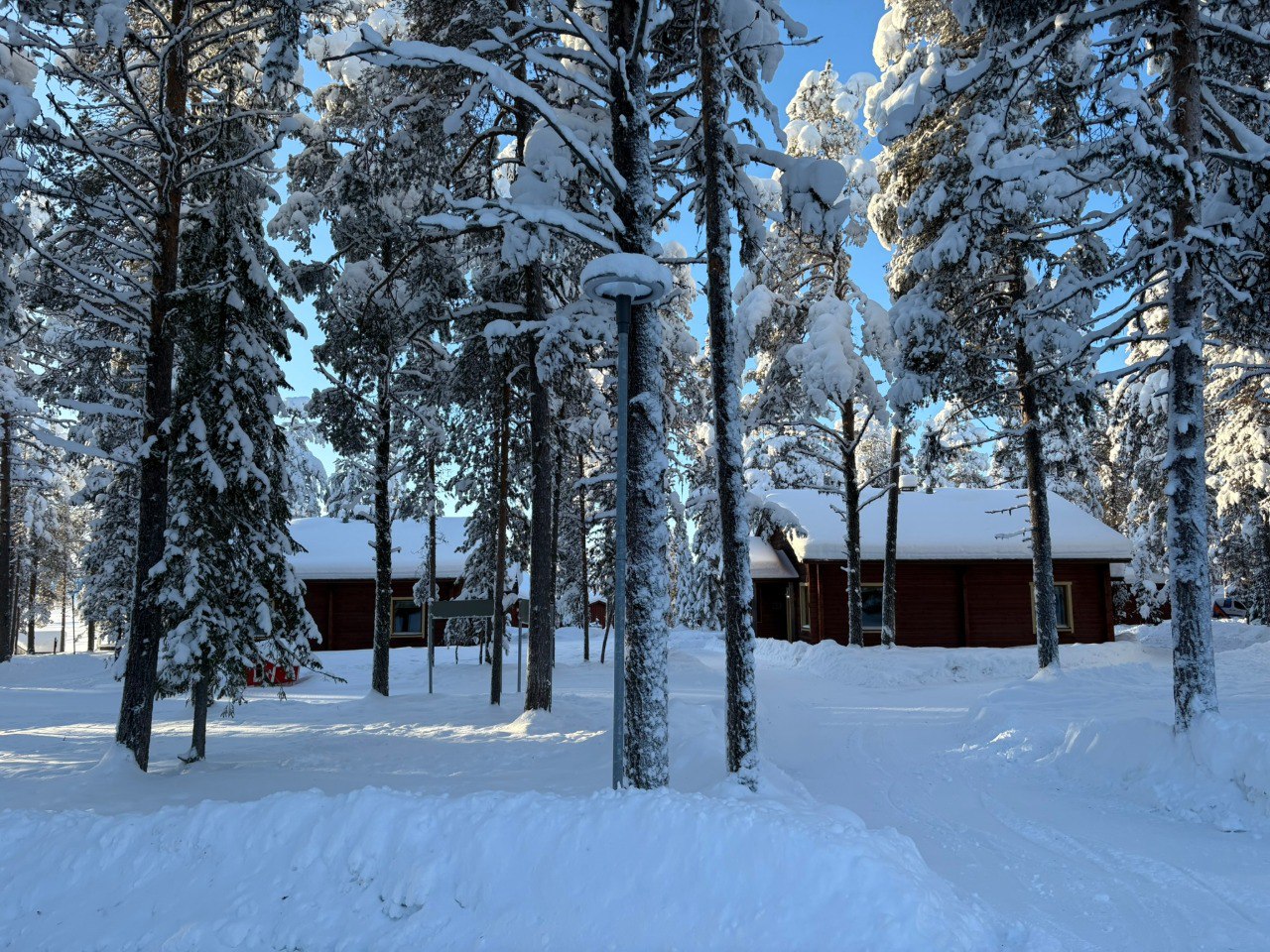 Family dressed in Arctic thermal gear playing in deep Lapland snow