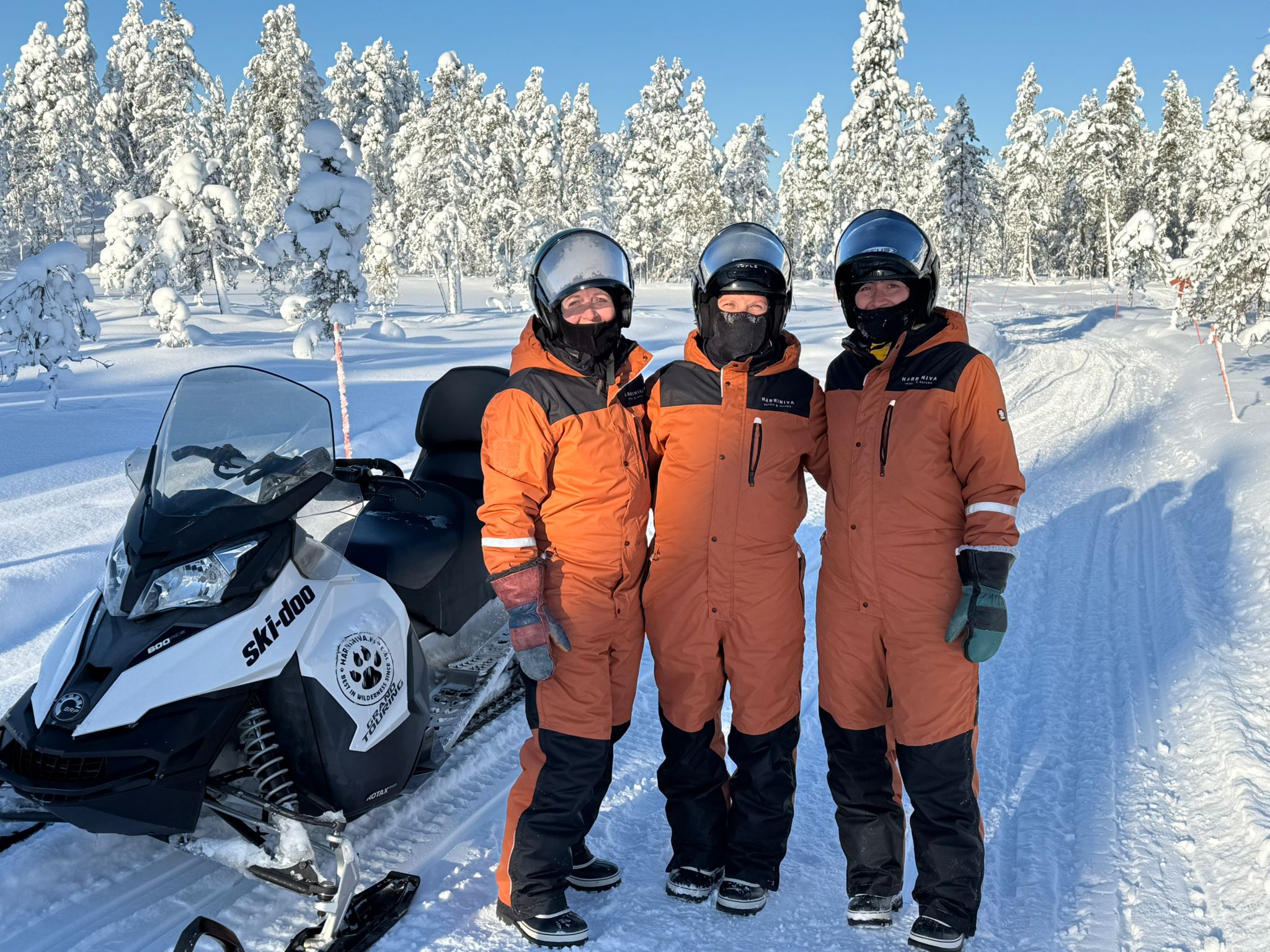 Snowmobiles gliding through deep snow and frozen Lapland forest